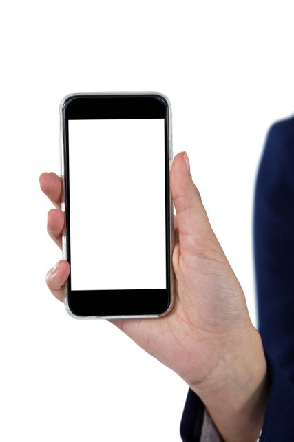 Hand of a businesswoman holding a smartphone with a blank screen against a white background. This versatile image is perfect for showcasing mobile applications, website designs, or digital communications in corporate materials.