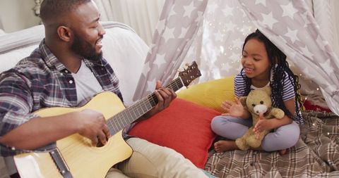 Father and Daughter Singing in Cozy Blanket Tent
