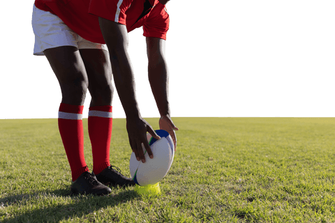 Transparent rugby player setting ball on field for kick