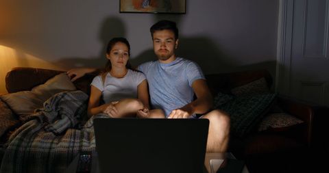 Couple in Intimate Relaxation Watching Laptop at Home