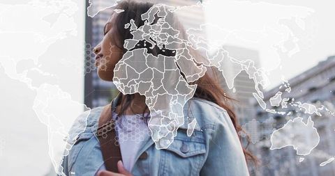 Young woman wearing denim jacket with world map overlay conveying global connectivity