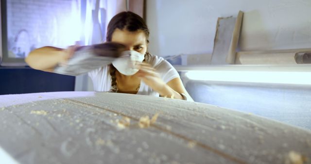 Female Carpenter Sanding Wooden Surfboard in Workshop - Download Free Stock Images Pikwizard.com