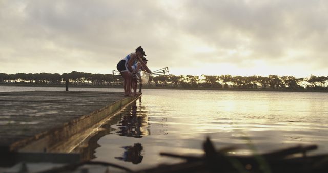 Friends Enjoying Fishing on Dock During Sunset by Lake - Download Free Stock Images Pikwizard.com