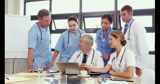 Multiracial medical team collaborates on patient care in a focused discussion. - Download Free Stock Photos Pikwizard.com