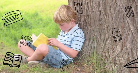 Young Boy Reading Book Under Tree Enjoying Outdoor Serenity
