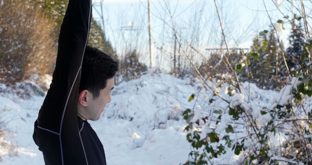 Man Stretching in Snow-covered Forest During Winter - Download Free Stock Images Pikwizard.com