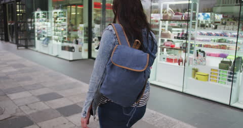 Urban Explorer Walking Using Smartphone in Daytime Cityscape