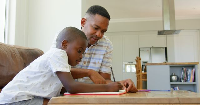 Caring Black Father Assisting His Son with Homework at Cozy Home - Download Free Stock Images Pikwizard.com