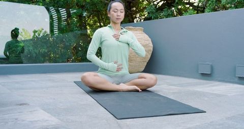 Serene Outdoor Meditation Practice by Asian Woman on Yoga Mat