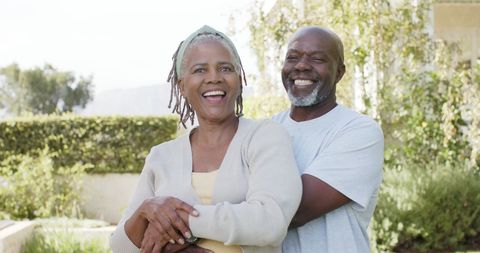 Joyful African American Senior Couple Embracing in Sunny Garden