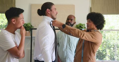 Friends supporting groom during wedding preparation