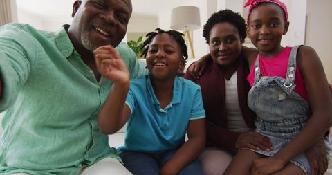 Happy Multigenerational Family Waving During Video Call