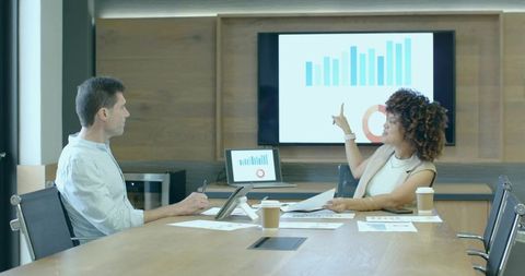 Professionals Analyzing Business Data in Modern Meeting Room