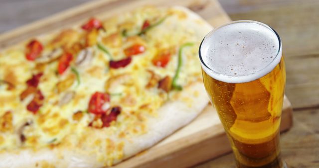Beer Glass with Freshly Baked Pizza in Background on Wooden Board - Download Free Stock Images Pikwizard.com