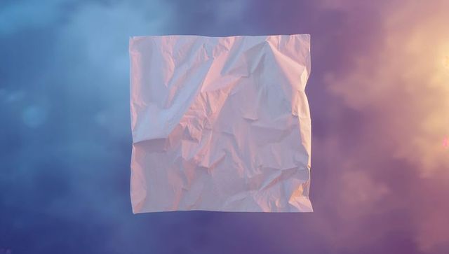 Floating crumpled paper in surreal dawn sky