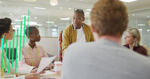 Diverse Team Collaborating in Modern Office with Digital Graph Overlays