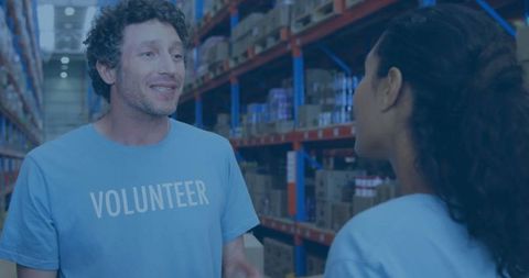 Volunteers sorting donations in distribution center warehouse setting