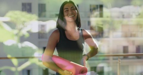 Smiling Woman Enjoys Active Exercise Lifestyle Holding Yoga Mat
