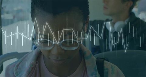 Woman Analyzing Data on Urban Bus with Overlayed Line Graph