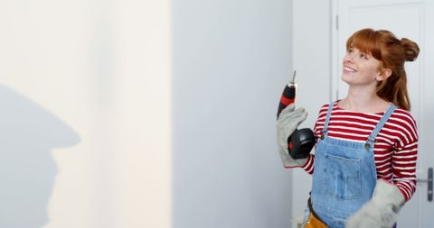 Smiling Woman Engaging in DIY Home Improvement Project - Download Free Stock Images Pikwizard.com