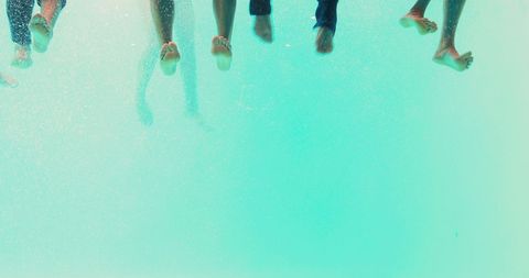 Diverse friends relaxing over clear turquoise water