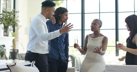 Diverse professionals networking and chatting in upscale modern living room lounge