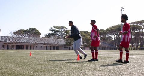 coach guiding young soccer players through agility drills - Download Free Stock Images Pikwizard.com