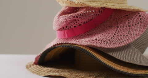 Close Up of Various Stylish Hats on Minimalist Background