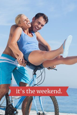 Joyful couple enjoying leisure time on beach bicycle ride