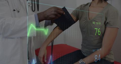 Doctor checking blood pressure with digital cardiograph interface