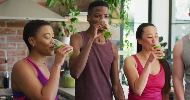 Diverse group of friends drinking green smoothies in modern kitchen - Download Free Stock Images Pikwizard.com