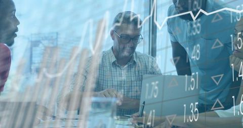 Business Team Collaborating on Data with Financial Chart Overlay