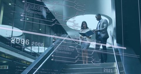 Business Professionals Discussing Reports on Modern Office Staircase