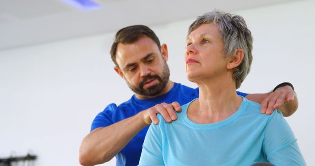 Physical Therapist Assisting Senior Woman with Shoulder Exercises - Download Free Stock Images Pikwizard.com