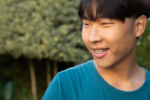 Smiling Young Man Outdoors in Golden Sunlight