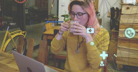 Woman enjoying a cozy cafe workspace with technology connection