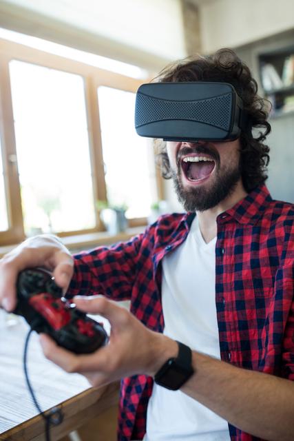 Young man enjoying virtual reality gaming experience in a coffee shop. Perfect for illustrating modern technology, gaming culture, and leisure activities. Ideal for use in articles, blogs, and advertisements related to VR technology, gaming, and lifestyle.