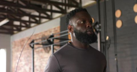 Focused Athlete Skipping Rope in Industrial Gym Setting