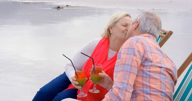 Elderly Couple Kissing on Beach with Drinks - Download Free Stock Images Pikwizard.com