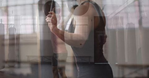 Man Performing Bicep Curls in Modern Gym Environment