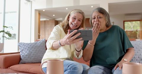 Senior Women Sharing Moments With Smartphone in Cozy Living Room