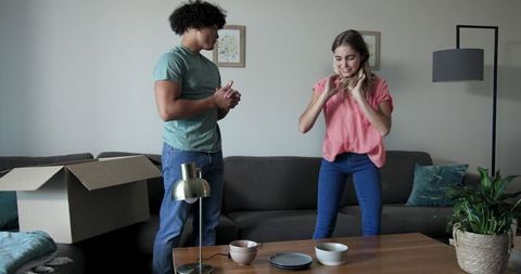 Young Couple Unpacking in Newly Arranged Living Room