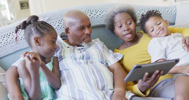 Grandparents Using Digital Tablet with Grandchildren on Couch - Download Free Stock Images Pikwizard.com