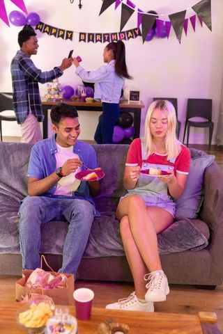 Diverse friends celebrating birthday at home social gathering