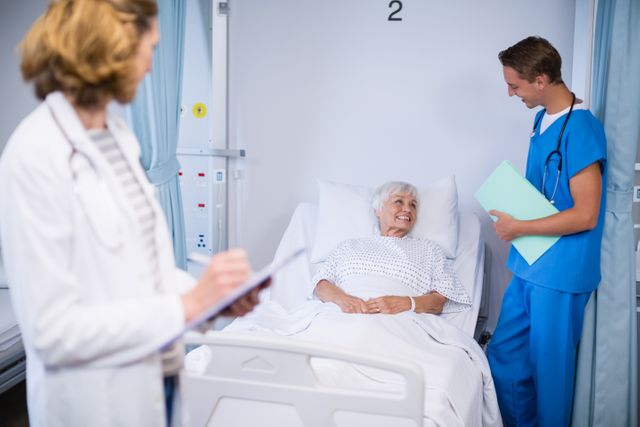 Doctors talking to a senior patient in hospital room