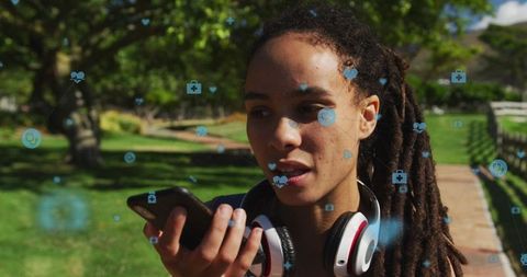 Woman engaged with health tech app in wooded outdoors