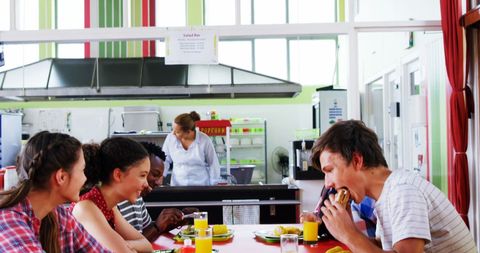 Diverse group enjoying meal in vibrant cafeteria setting