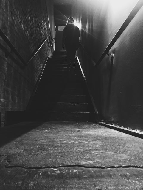 Silhouetted Person Climbing Dark Staircase - Download Free Stock Photos Pikwizard.com