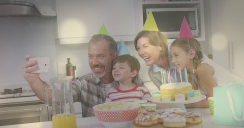 Family Celebrating Birthday Together with Party Hats and Cake - Download Free Stock Images Pikwizard.com