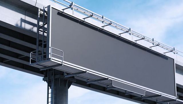 Blank billboard on concrete overpass with metal ladder and grated catwalk, urban signage